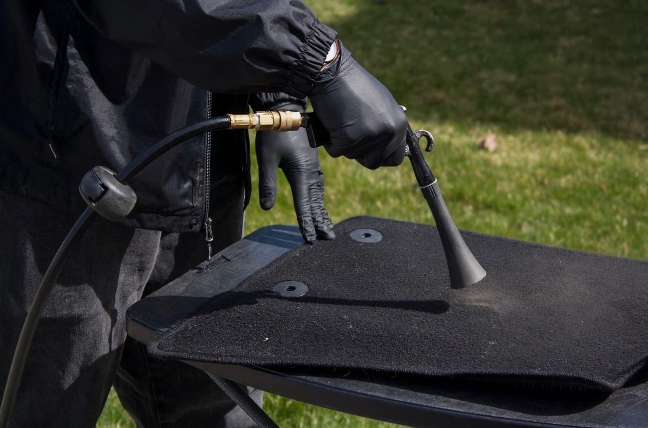 Waypoint professionally cleaning a vehicle floor mat